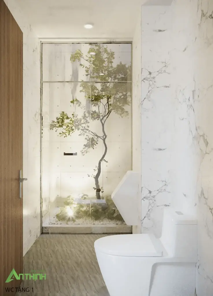WC tầng 1 đặc biệt – ốp marble trắng sạch, phía sau kính là cây xanh thật trồng trong hốc, tạo cảm giác đi WC như đang ở giữa thiên nhiên