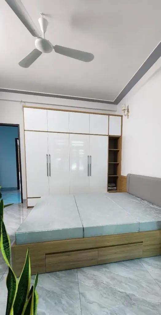 Ảnh thực tế – phòng ngủ tủ áo trắng có kệ mở vân gỗ